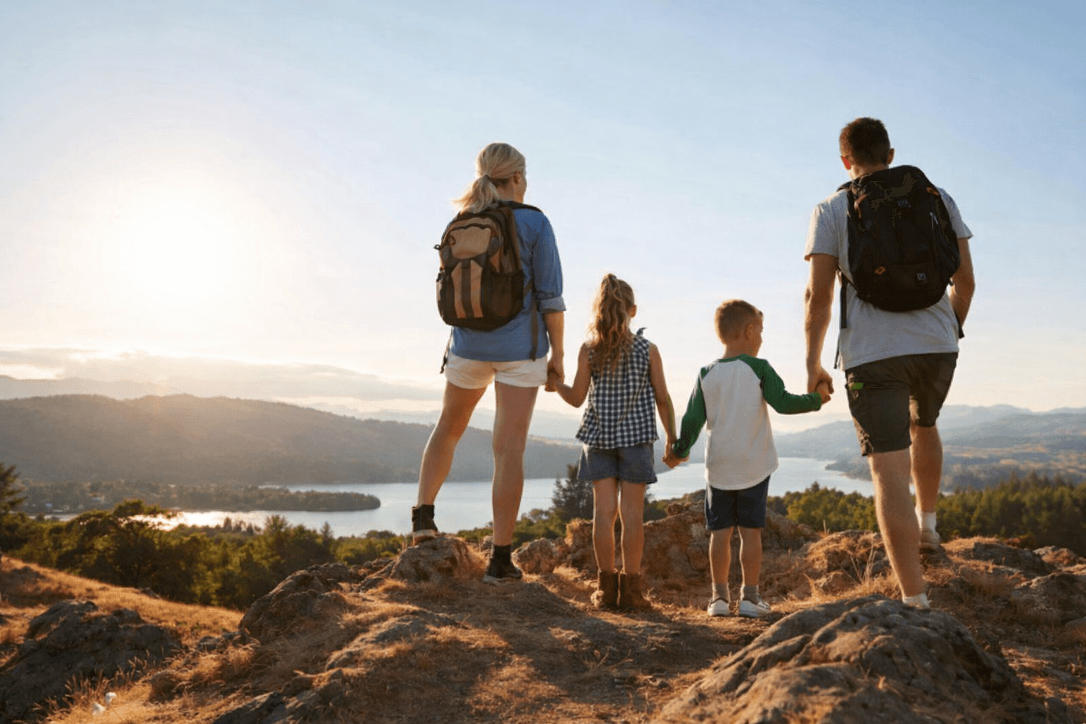 Family hiking together at sunset